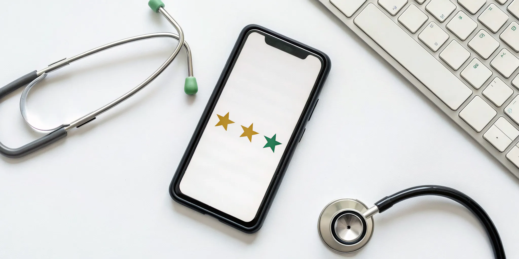 concierge-medicine-reviews-the-good-bad–the-cost-894635 A mixed three-star review of concierge medicine on a smartphone next to a stethoscope.